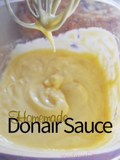 a whisk is being used to mix ingredients in a bowl with the words homemade donar sauce