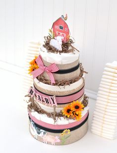 a three tiered cake decorated with sunflowers and farm animals on the side