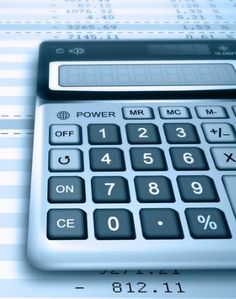 a calculator sitting on top of a sheet of paper with numbers in the background