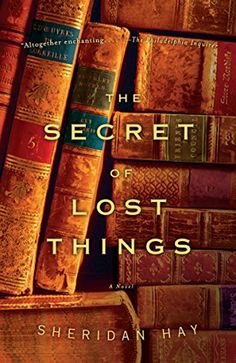 the book cover for the secret of lost things by sheridhan hay, with several books stacked on top of each other