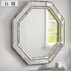 a mirror is hanging on the wall next to a table