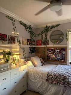 a bedroom with plants growing on the wall above the bed and below the bed is a dresser