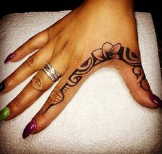 a woman's hand with a tattoo on it and two rings around her finger