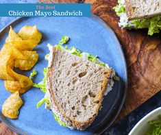 a blue plate topped with a sandwich and chips