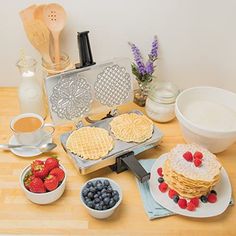 pancakes, strawberries and other breakfast foods on a table