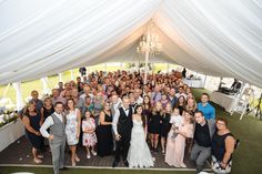 a large group of people standing under a tent