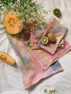 a table topped with different types of fruits and vegetables next to each other on napkins