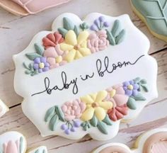 baby in bloom decorated cookies on a table