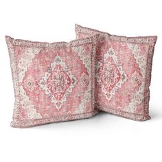 two pink and white pillows with an intricate design on the front, one is made out of