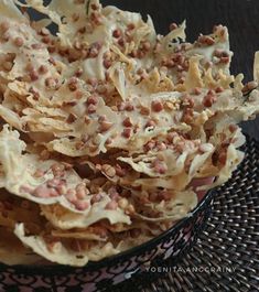 a bowl filled with food sitting on top of a table