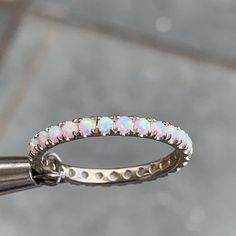 a close up of a ring with opals on it