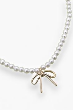 Get ready to elevate your accessory game with the stunning Pearl Chain Bow Charm Necklace . Imagine draping this beauty around your neck, combining the timeless elegance of pearls with the chic charm of a delicate bow pendant. With a length of 16 inches, plus an additional 3-inch extender for the perfect fit, this necklace features a sophisticated pearl-adorned chain that exudes both grace and style. The lobster claw clasp ensures it stays securely in place from morning meetings to evening outings. Each pearl captures the light just right, making this piece a versatile addition that can elevate any outfit. Plus, it's lead and nickel compliant, offering peace of mind for sensitive skin.   Features:  
Elegant Pearl Chain: Measures 16 inches with an additional 3-inch extender. 
Charming Bow P Morning Meetings, Bow Pendant, Pearl Chain, The Chic, Lobster Claw, Charm Necklace, Sensitive Skin, Timeless Elegance, Perfect Fit