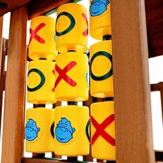 there are many yellow and green tic - tacs on the wooden stand together