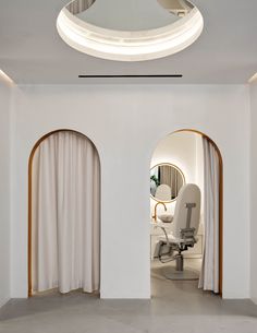 an office space with white walls and arched doorways