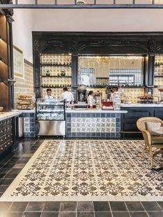 the interior of a restaurant with black and white tile