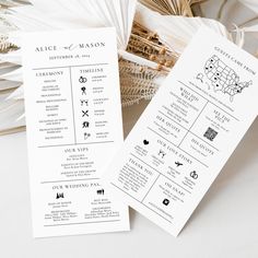 two wedding programs are sitting next to each other on top of a white table cloth