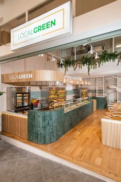 the inside of a local green store with wooden floors