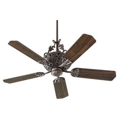 a ceiling fan with four wooden blades and two metal flowers on the blade, against a white background