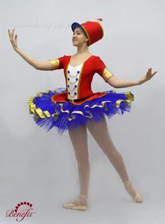 a woman in a red and blue dress is doing some ballet moves with her arms out