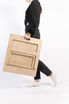 a woman carrying a large piece of furniture on her back with one foot in the air