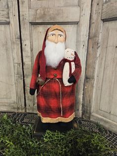 Medium Primitive Santa with Red Plaid Coat Holding Snowman Red Plaid Coat, Primitive Ornaments, Primitive Christmas Decor, Primitive Lighting, Primitive Wood Signs, Flameless Tea Lights, Primitive Candles, Primitive Walls, Stocking Hanger