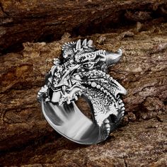 Cool massive ring with a Dragon, made of sterling silver - will adorn you or your loved one! Men's silver ring is a great gift for the New Year and Christmas, father of the bride gift! The dragon is a symbol of the coming new year. Perfect for those born in the Year of the Dragon. The strength of the dragon is not just brute strength, it is combined with wisdom. The dragon is often portrayed as the keeper of hidden knowledge. This ring represents the concept of intelligence and insight, a powerful tool wielded by those who seek to carve their way through the thick of uncertainty. We invite you to the store of exclusive jewelry handmade in the styles of gothic, steampunk, skull, viking, slavic, norse, amulets, scandinavian, masonic, muslim, engagement, wedding. Personalization possible Mate Symbolic Skull Ring Gift, Symbolic Skull Ring With Open Design, Symbolic Skull Ring Gift Open Ring, Symbolic Skull Open Ring As Gift, Symbolic Rings With Unique Design For Gift, White Gold Polished Skull Ring Gift, White Gold Skull Ring With Polished Finish Gift, White Gold Skull Ring With Polished Finish, Engraved Open Skull Ring As Gift