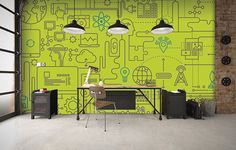 an office with green wallpaper and two lamps hanging from the ceiling over a desk