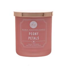 a pink candle that says peony petals on the front and side, with a gold lid