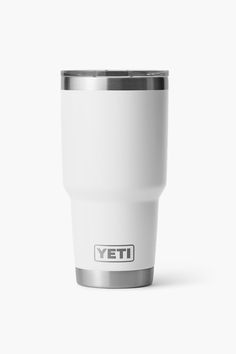 a white yeti cup with the word yeti on it's side, sitting against a white background