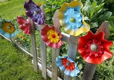 colorful flowers are placed on the side of a fence