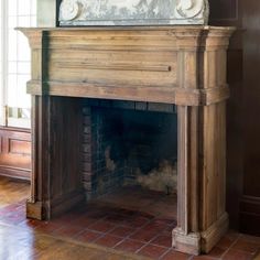 an old fireplace with a mirror above it