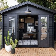 a black shed with a computer on the desk