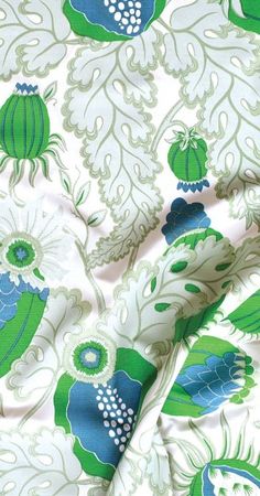 an image of green and blue flowers on white fabric