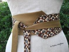 a woman wearing a brown belt with an animal print design on it