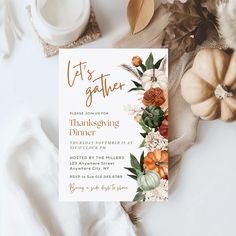 a thanksgiving dinner party with pumpkins, flowers and leaves on the table next to it