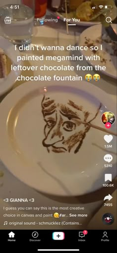 a white plate topped with a drawing of a face