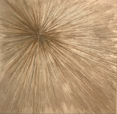 an abstract painting with gold paint and lines in the center, on a beige background