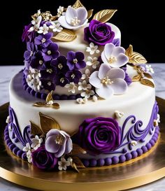 a three tiered cake with purple and white flowers on the top is sitting on a gold platter