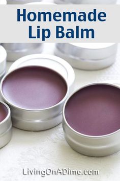 some tins with purple lip balm in them on a white table and text overlay reads homemade lip balm