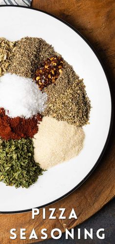 a white plate topped with different types of seasoning on top of a wooden table