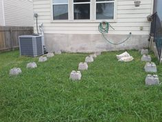 the lawn is covered with plastic bags and there are several air conditioners in front of the house