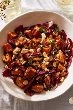 a white bowl filled with food on top of a table