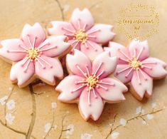 some pink flowers are sitting on a table