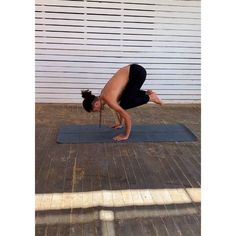 a person doing a yoga pose on a mat