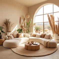 a living room filled with lots of furniture and large windows overlooking the desert outside it