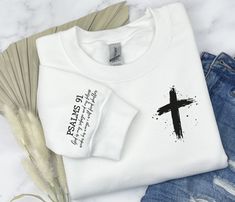 "PSALM 91 Sweatshirt, Christian Shirt, Bible Verse Sweatshirt, Faith Hoodie, Cross T shirts, Faith Tshirts, Religious Sweater, DKP6200 H O W  TO  O R D E R 1️⃣Please, check and review all the photos. 2️⃣ Choose your T-shirt size and color. 🔵Different styles of shirts may have different shades of same color choice due to different manufacturer brands. 🔵For this reason, we recommend you to match shirts from the same styles if you want precisely matching colors (ex. Unisex, V-necks, Toddler, etc. Matching Christian Shirts, White Hoodie T-shirt For Winter, White Hoodie With Screen Print, White Screen Print Hoodie, Pre-shrunk White Hoodie Sweatshirt, White Pre-shrunk Hoodie Sweatshirt, Bible Verse Sweatshirts, Christian Hoodie Design, Cute Christian Sweatshirts