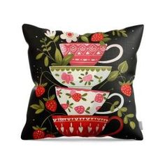 three teacups and strawberries on black pillow cover with red trimming, one is