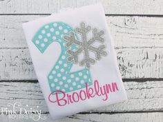 a snowflake number two applique on a white shirt with polka dots