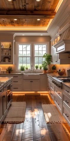 a kitchen with wood flooring and white cabinetry has lights on the ceiling above the stove