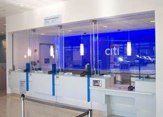 an airport terminal with glass walls and blue lights